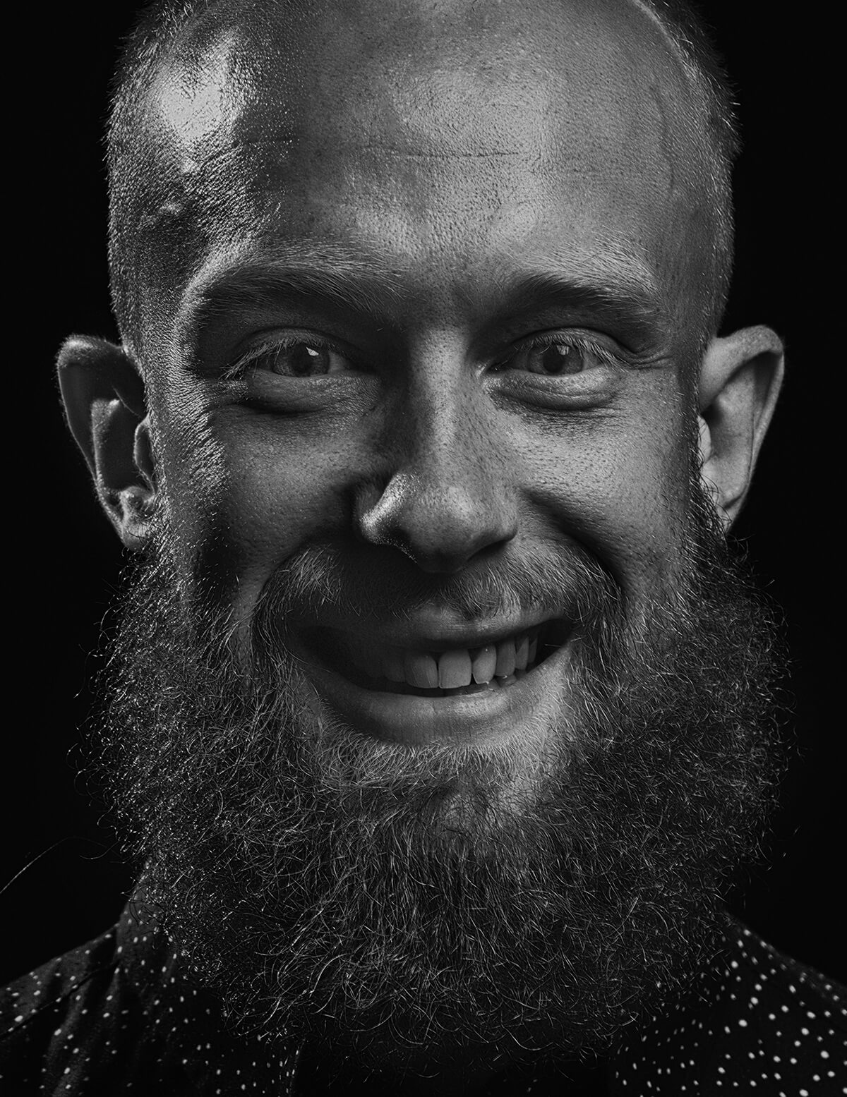 Man with piercing eyes smiling